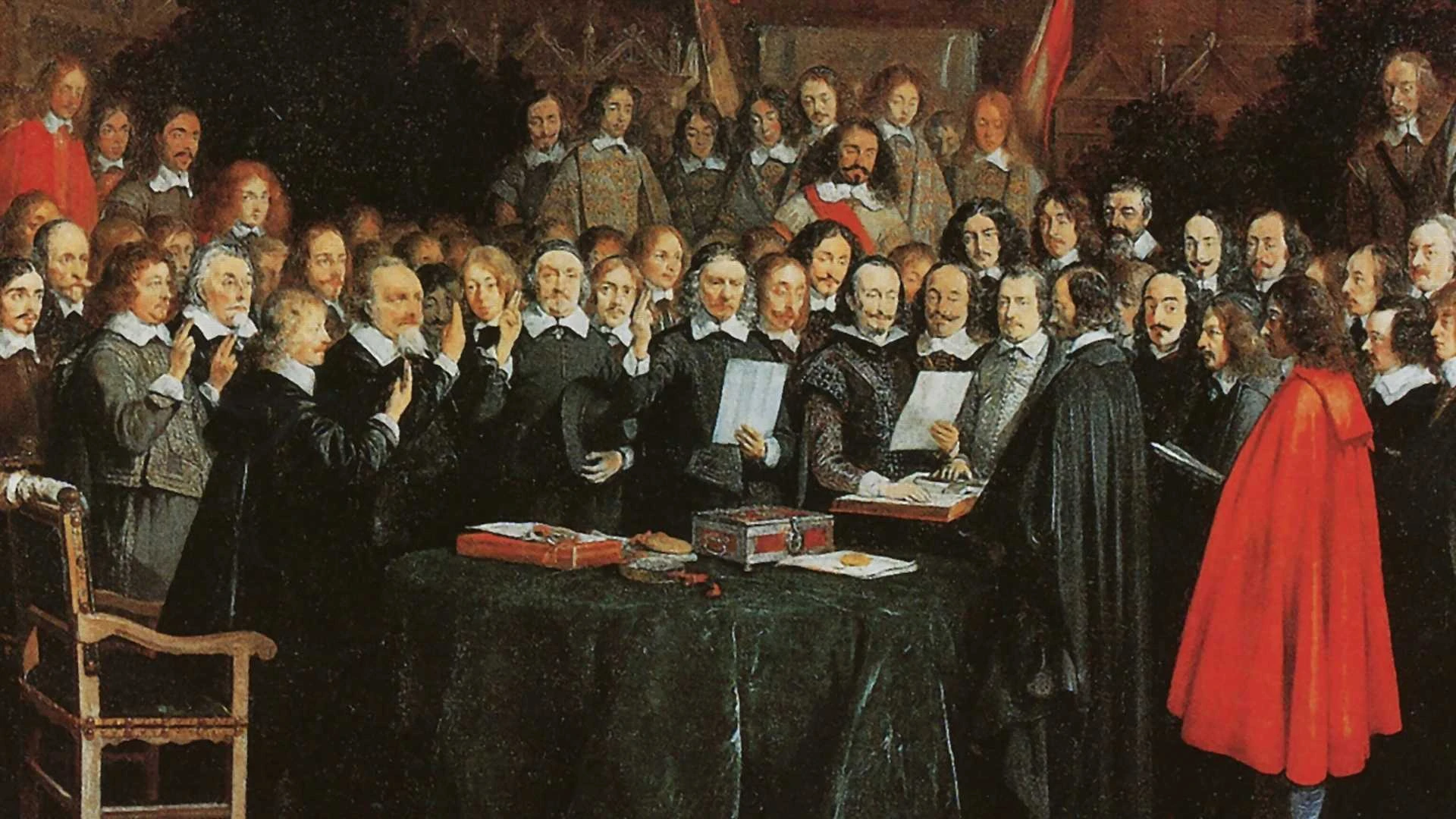 Eine Gruppe von Männern in historischer Kleidung versammelt sich um einen Tisch und prüft Dokumente, während im Hintergrund weitere Personen stehen.