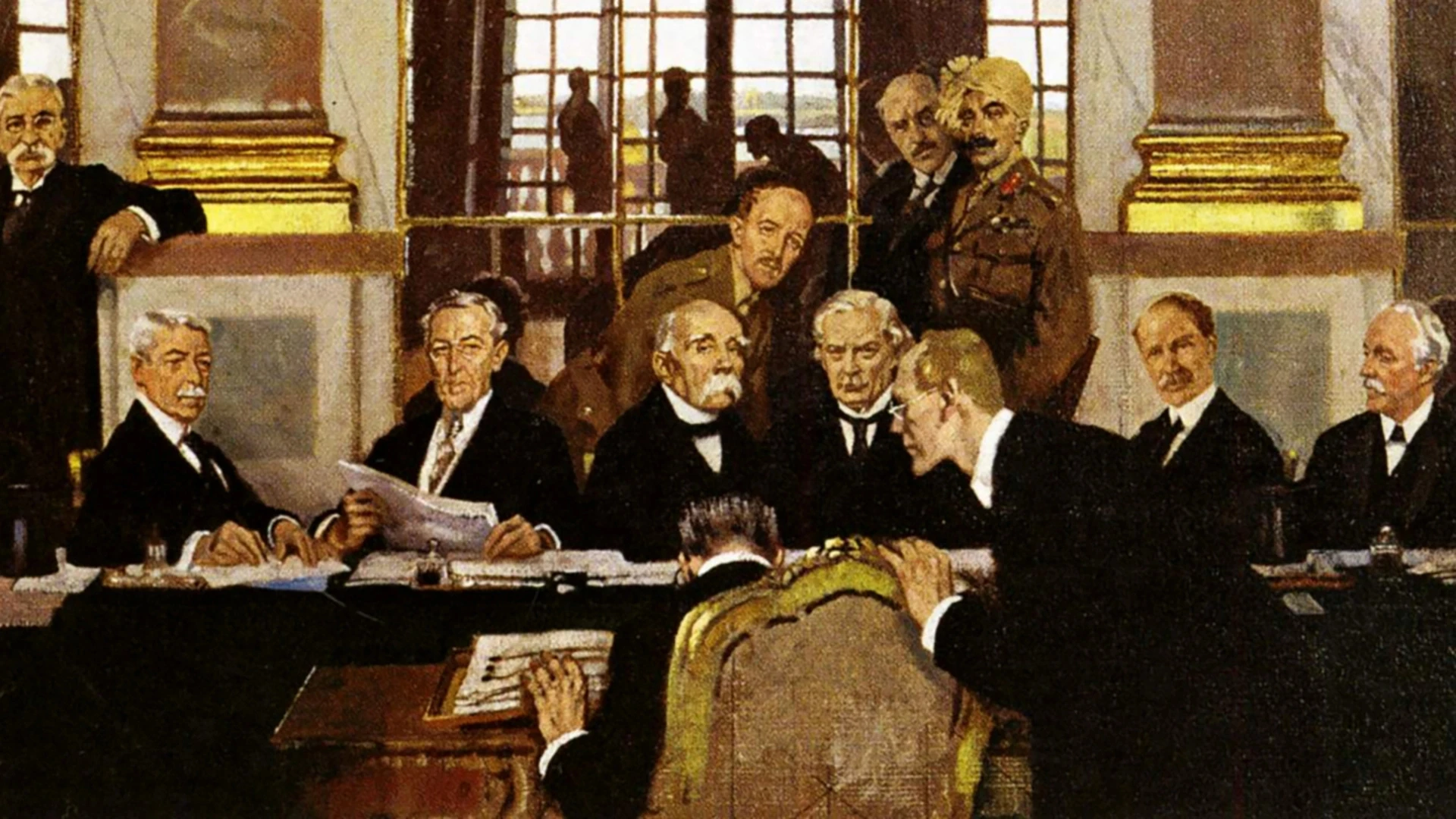 Eine Gruppe formell gekleideter Männer sitzt und steht in einem großen Raum mit großen Fenstern im Hintergrund um einen Tisch herum und diskutiert.